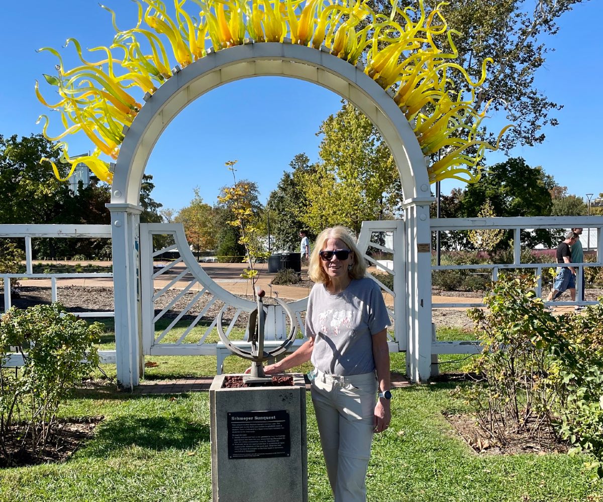 Karen standing next to a statue.