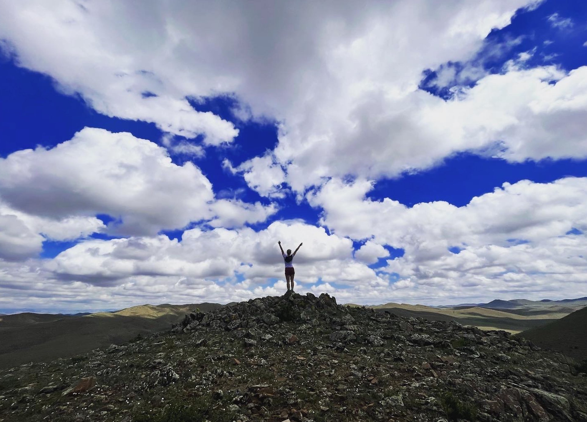 Student standing on rocks