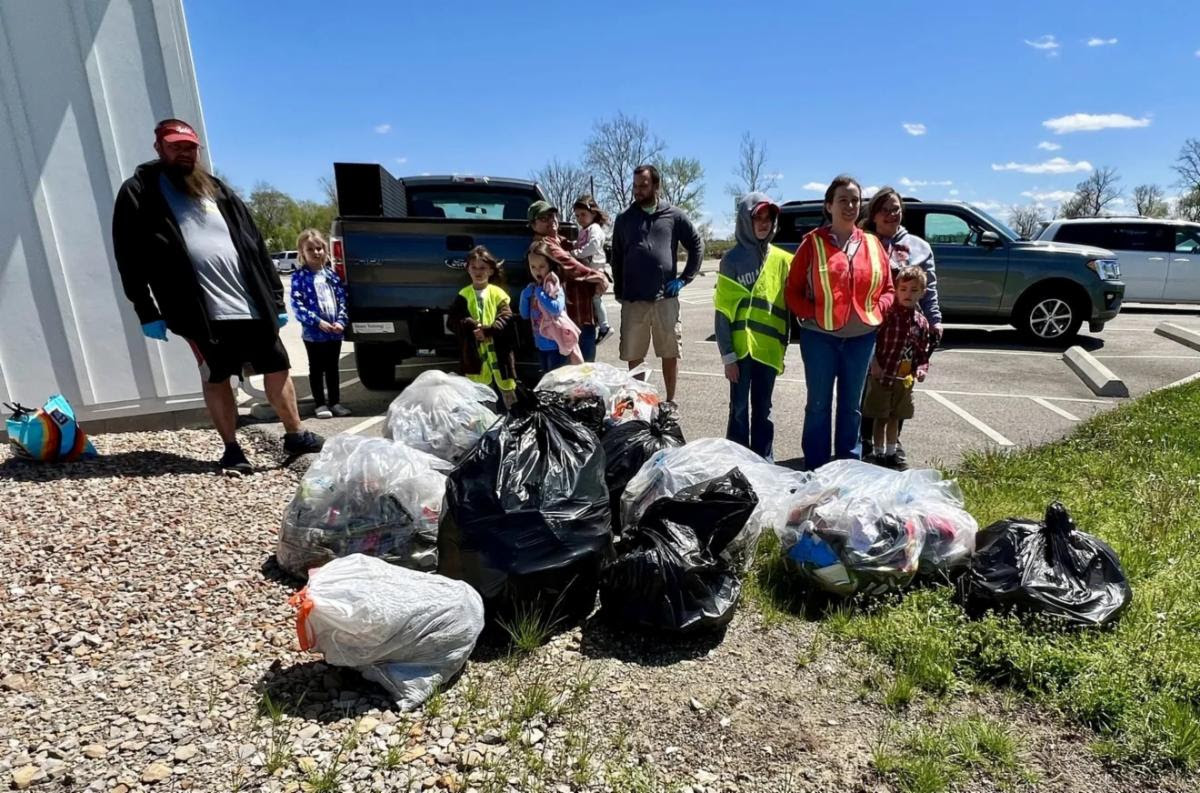 Group of people standing over their collected trash.