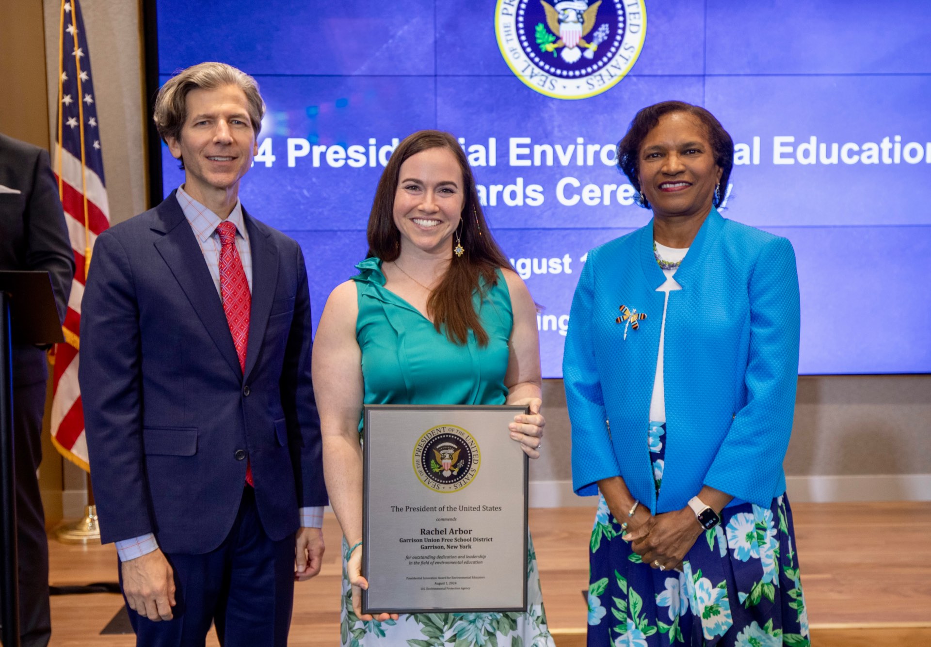 Rachel Arbor accepting the Presidential Innovation Award and standing with The Honorable Brenda Mallory, Chair, Council on Environmental Quality from the White House and Mark Rupp, the Assistant Deputy Administrator of the EPA.