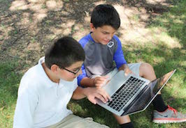 kids looking at laptop 