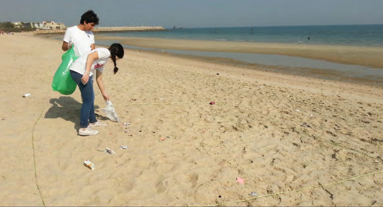 people picking up beach trash