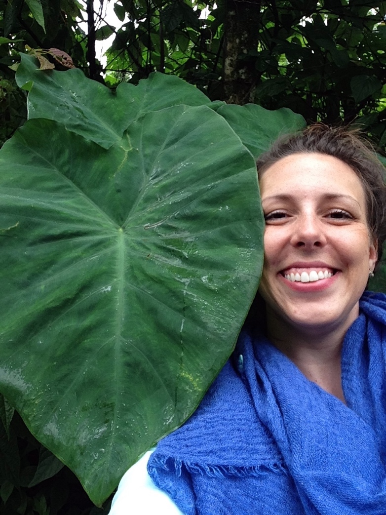 A student with a large leaf next to her head.