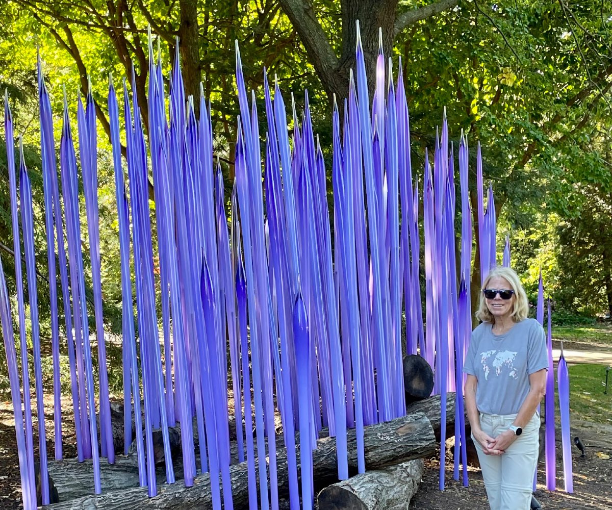 Karen standing in front of tall purple glass.