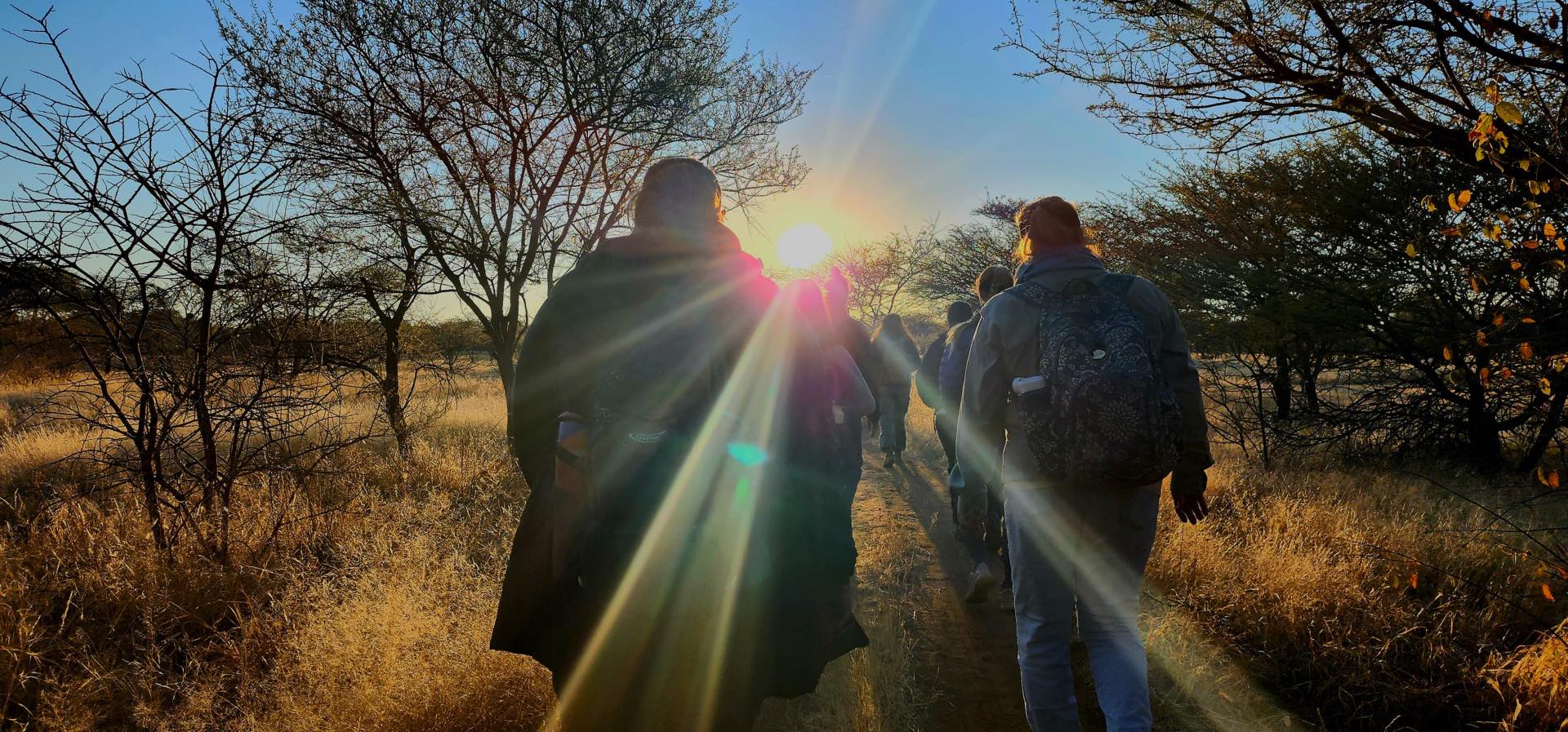 Students walking into the sun rise