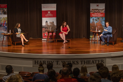 Rosie Rios, Reena Murphy, and Todd Buchholz on the Wilks Theater stage for the October 2021 Janus Forum.