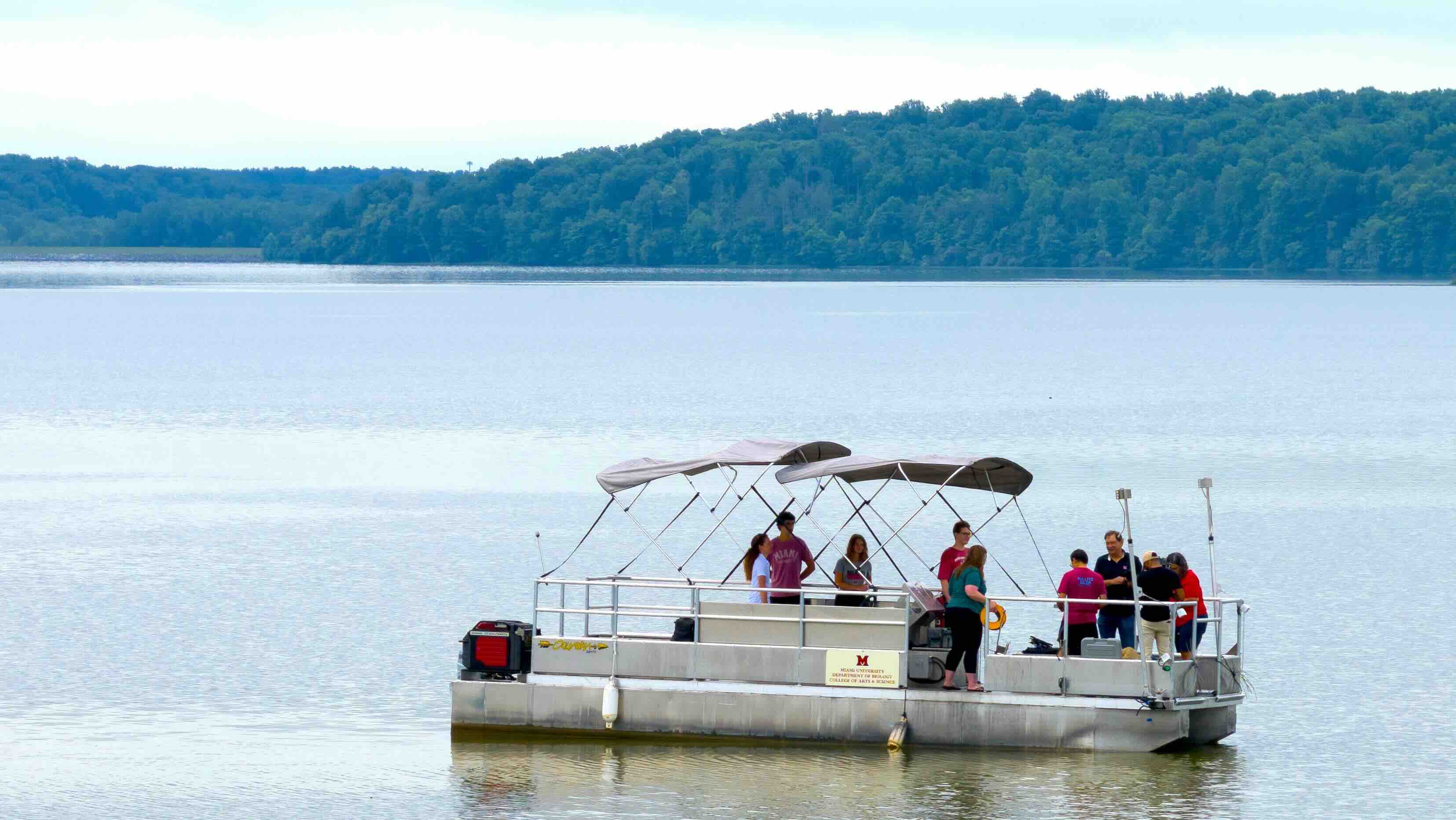 Students and faculty on a Department of Biology research boat in Acton Lake