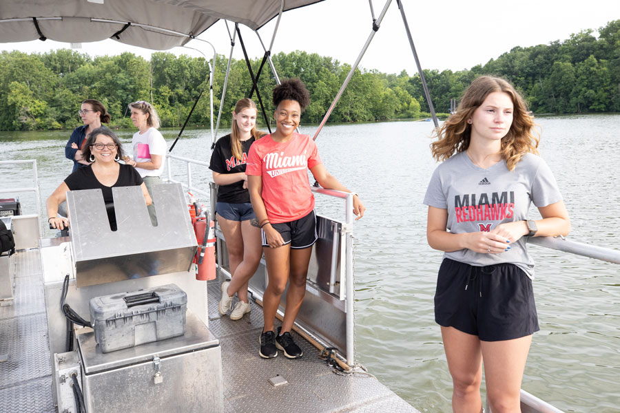 Lesley Knoll pilots a Department of Biology research boat with her students in Acton Lake