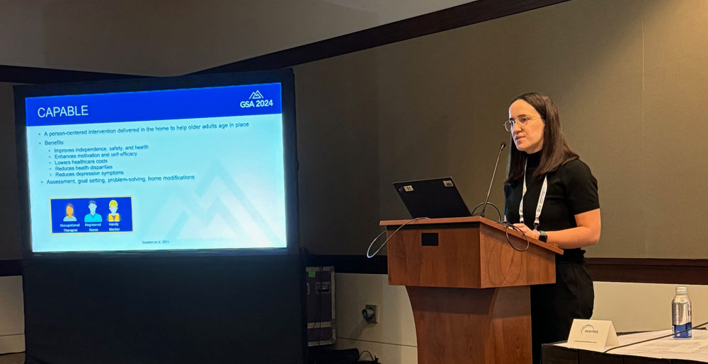 Kate Perepezko at a podium giving a presentation.