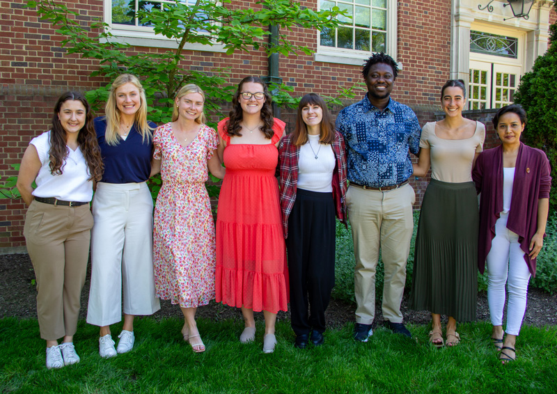Eight student pose for a group shot. 