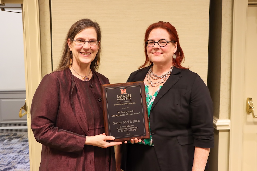 Katy Abbott with Susan McGeehan holding the award plaque. 