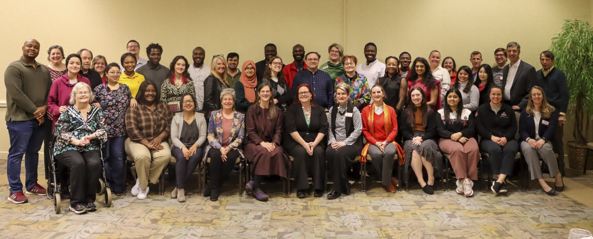 Group of 50 student and researchers gathered around the awardee in the center. 