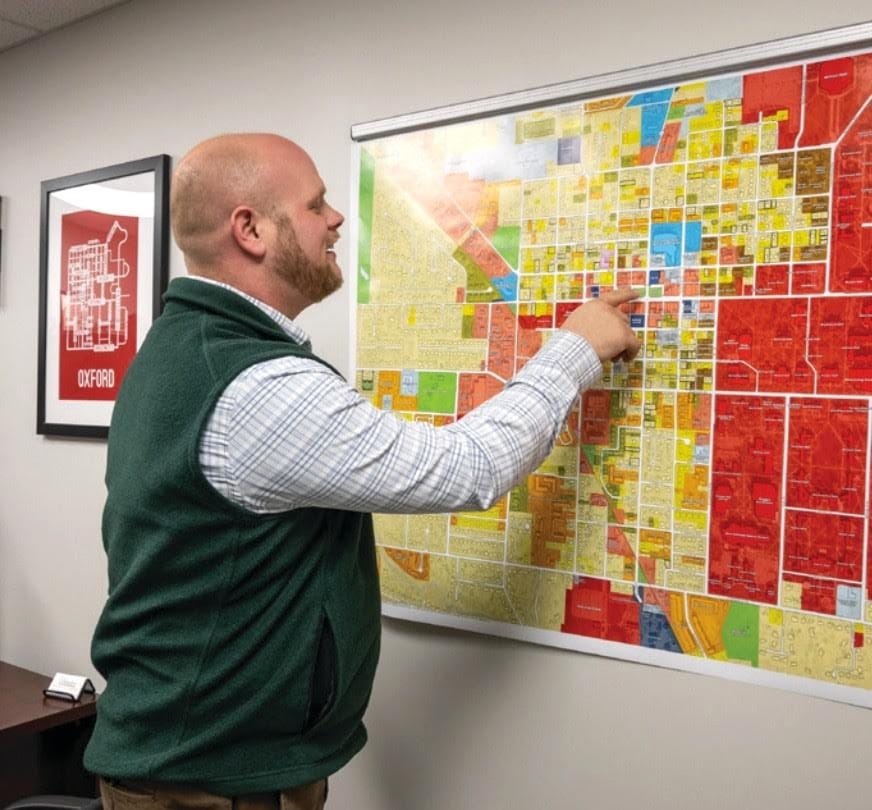 Zachary Moore points at an existing land use map in his office. Photo provided by Zachary Moore.