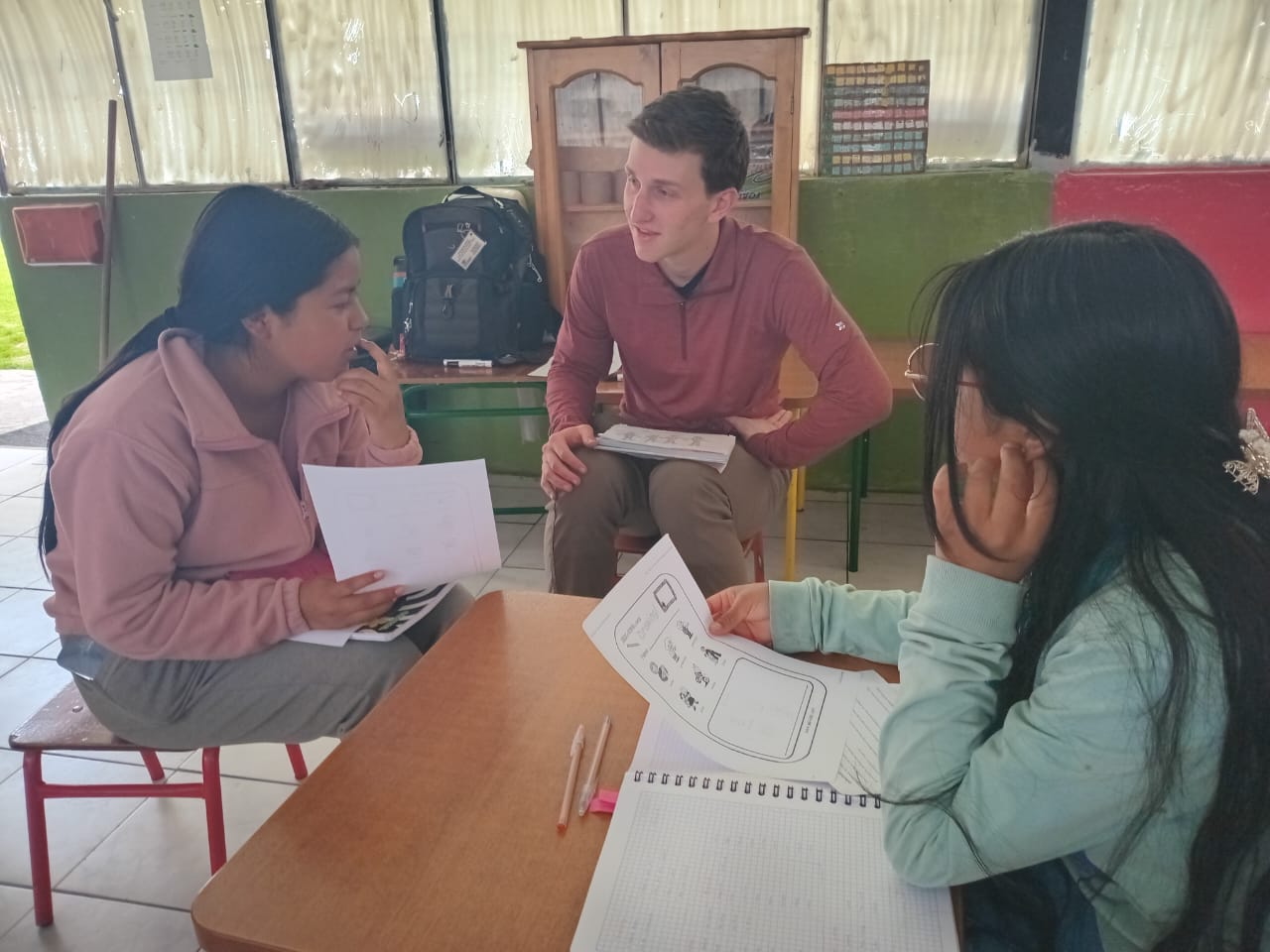 Sam Laikin helping students practice speaking in English.