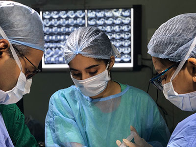 Esha Chadha (middle) working on a cadaver in India