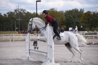 Skyler jumping her horse as a member of the Miami Equestrian Team.