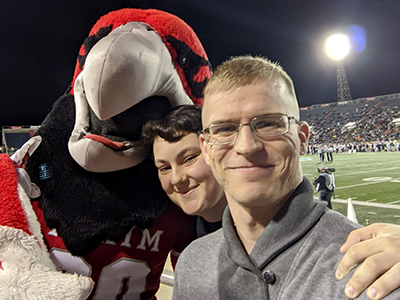 Swoop, Rachel Sullivan, and a friend at a Miami University football bowl game