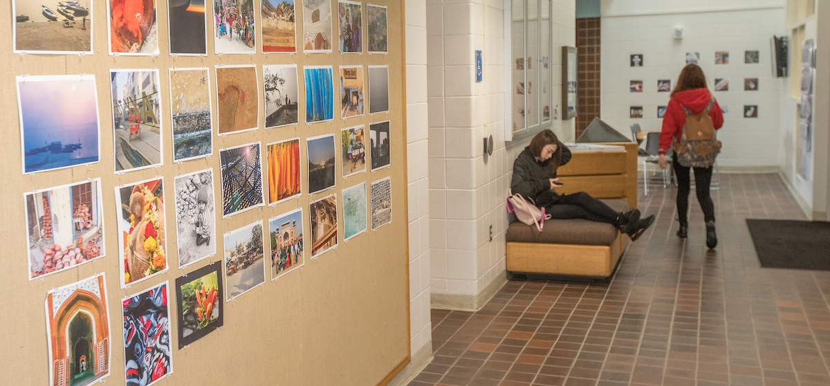 hallway in the art building with student work displayed on the walls