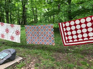Quilts displayed on a clothesline