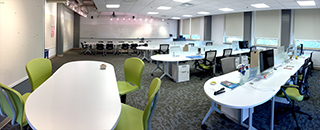 the xdMFA studio room with tables and chairs