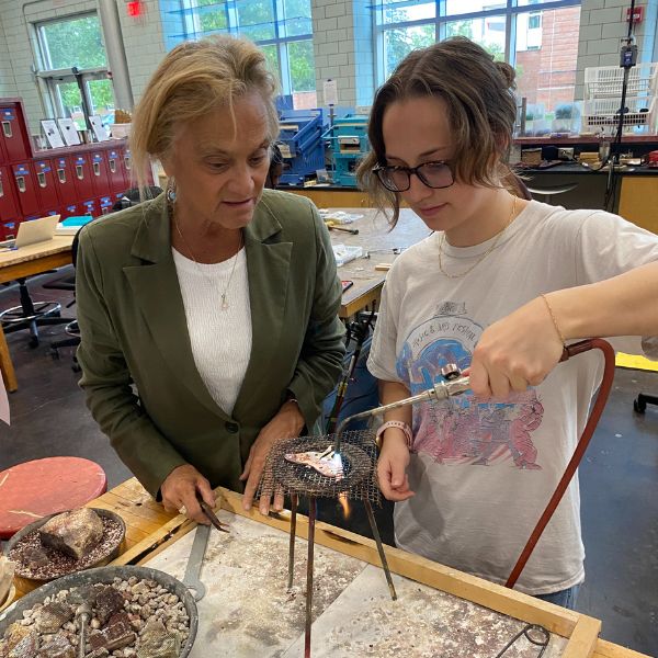 metalsmithing student with instructor
