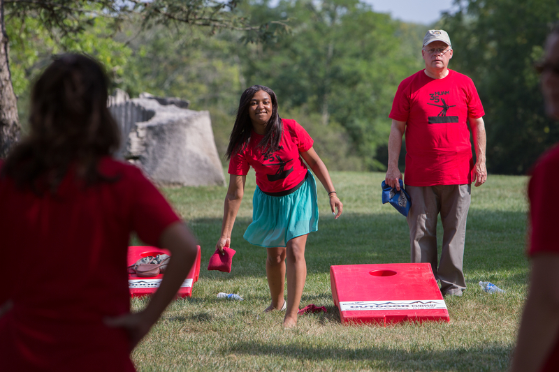 female student and male faculty member playing cornhole