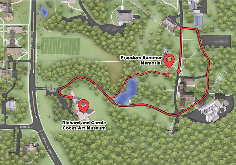 two routes leading to the Freedom Summer memorial from the Richard and Carole Cocks Art Museum with the solid line indicating a route by car and the dashed line indicating a walkable route