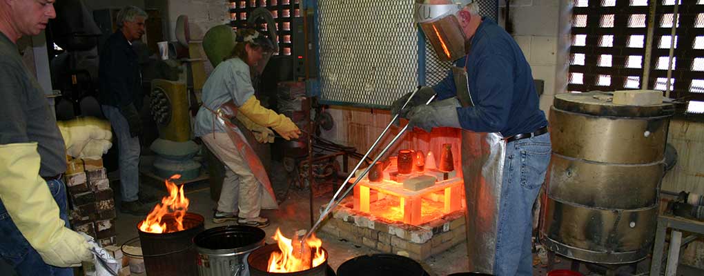 students working with fire to melt bronze for jewelry making