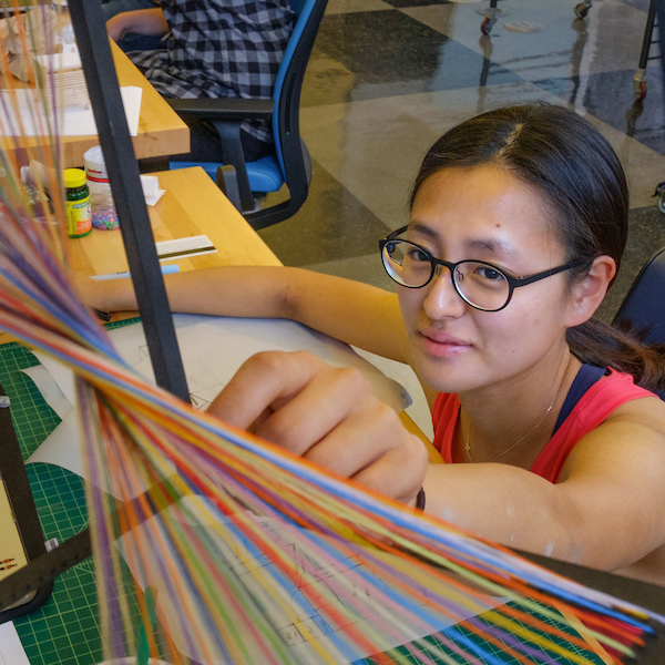 student working with materials in design studio