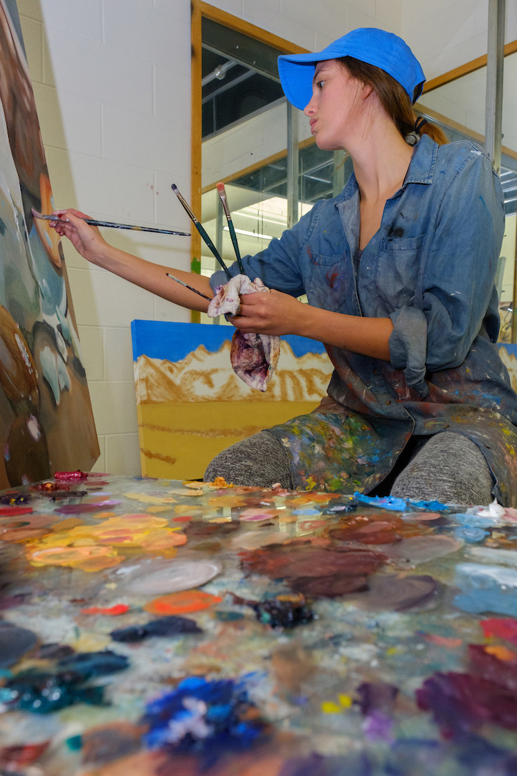 student painting at an easel