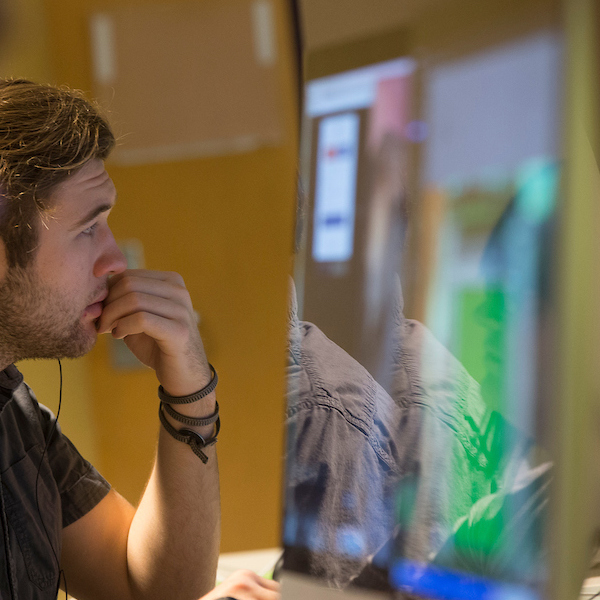 male student working on computer