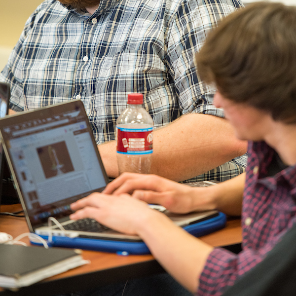 student on laptop during game jam