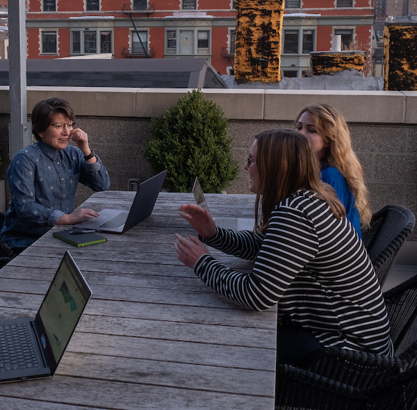 small group of students meeting on patio