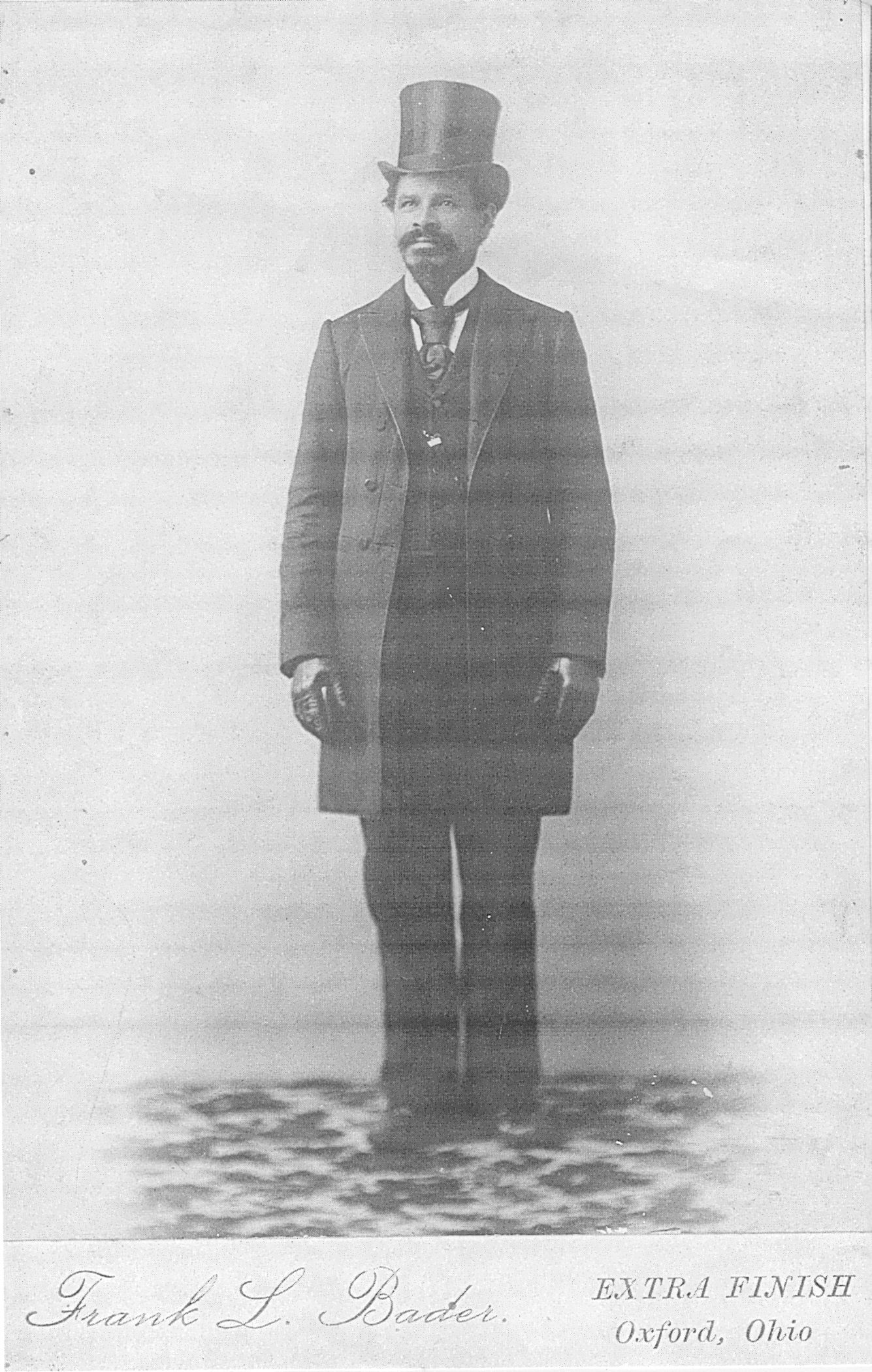 Full length studio portrait of Peter Bruner, wearig his silk top hat, photographed by Frank L Bader