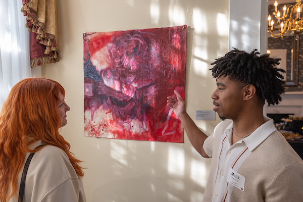 people looking at artwork