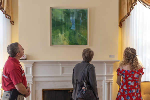 people looking at artwork