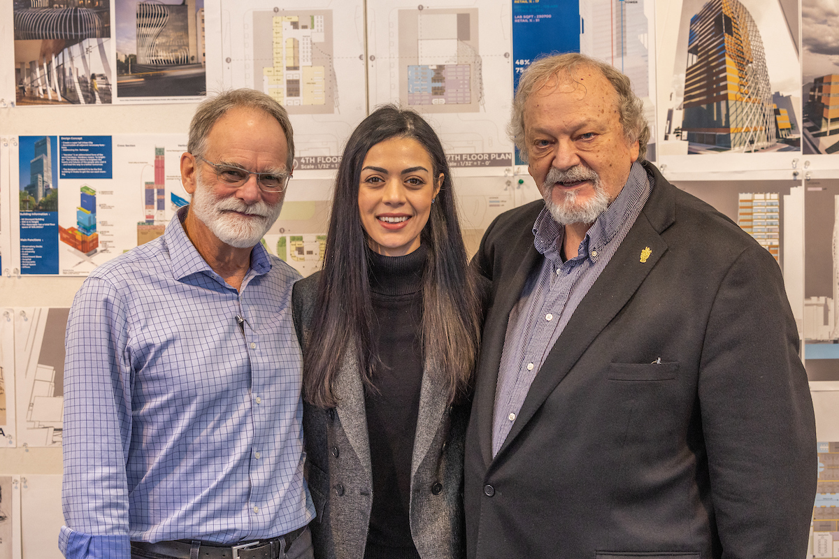 three people smiling at the camera