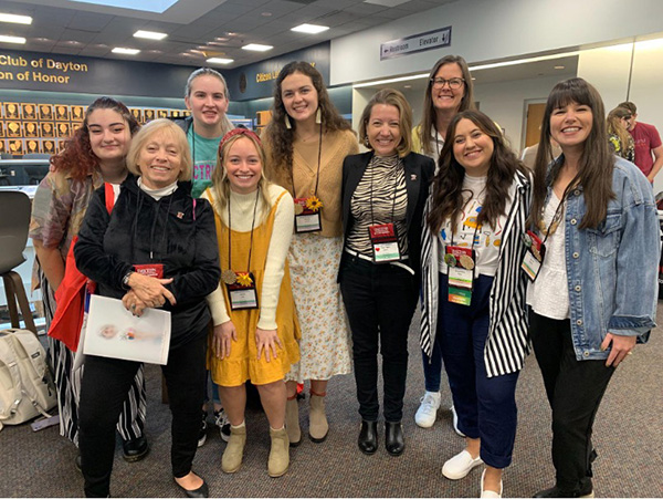 students smiling at a camera