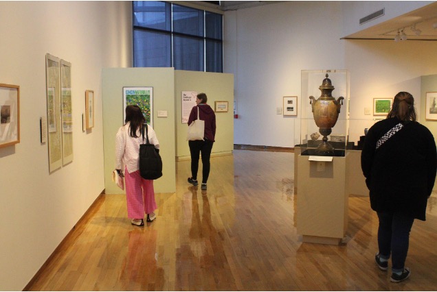 Participants walk around the galleries at the Richard and Carole Cocks Art Museum