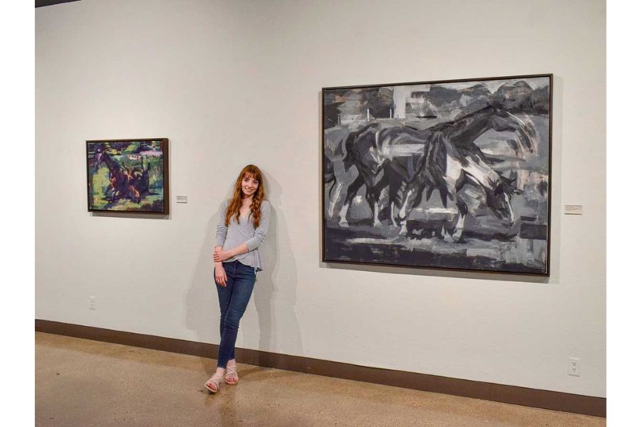 Sarah-Faith Strait standing next to her artwork