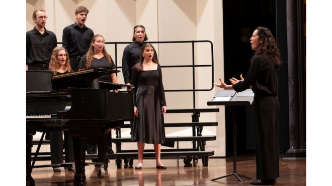 a choir performing with a conductor