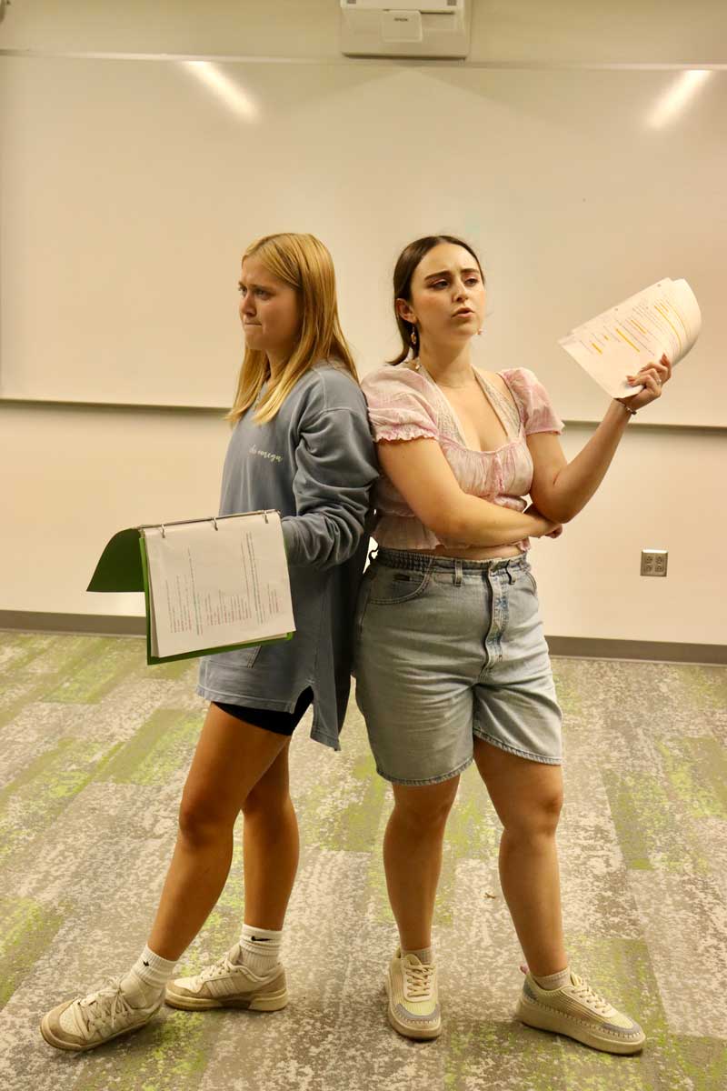 Anna Maki and Mallory Branek performing a scene during rehearsal