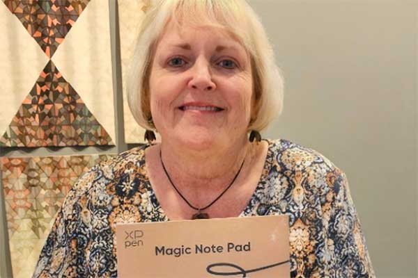Susan Ruttle Lawrence, Director of the Art Education Program at Mount St. Joseph University, poses with her XPPen Magic Note Pad grand prize.