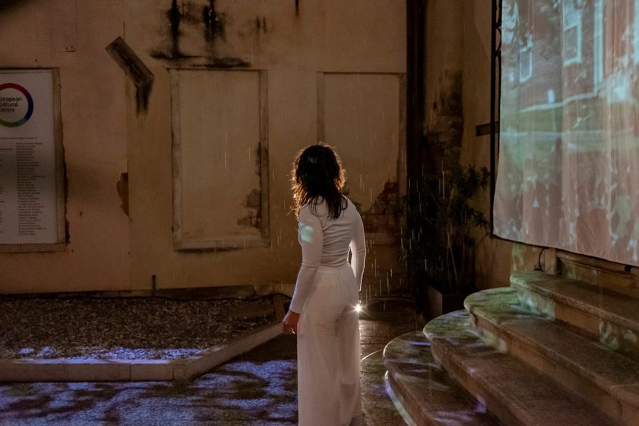 Ashley Goos with her back to the camera in the rain