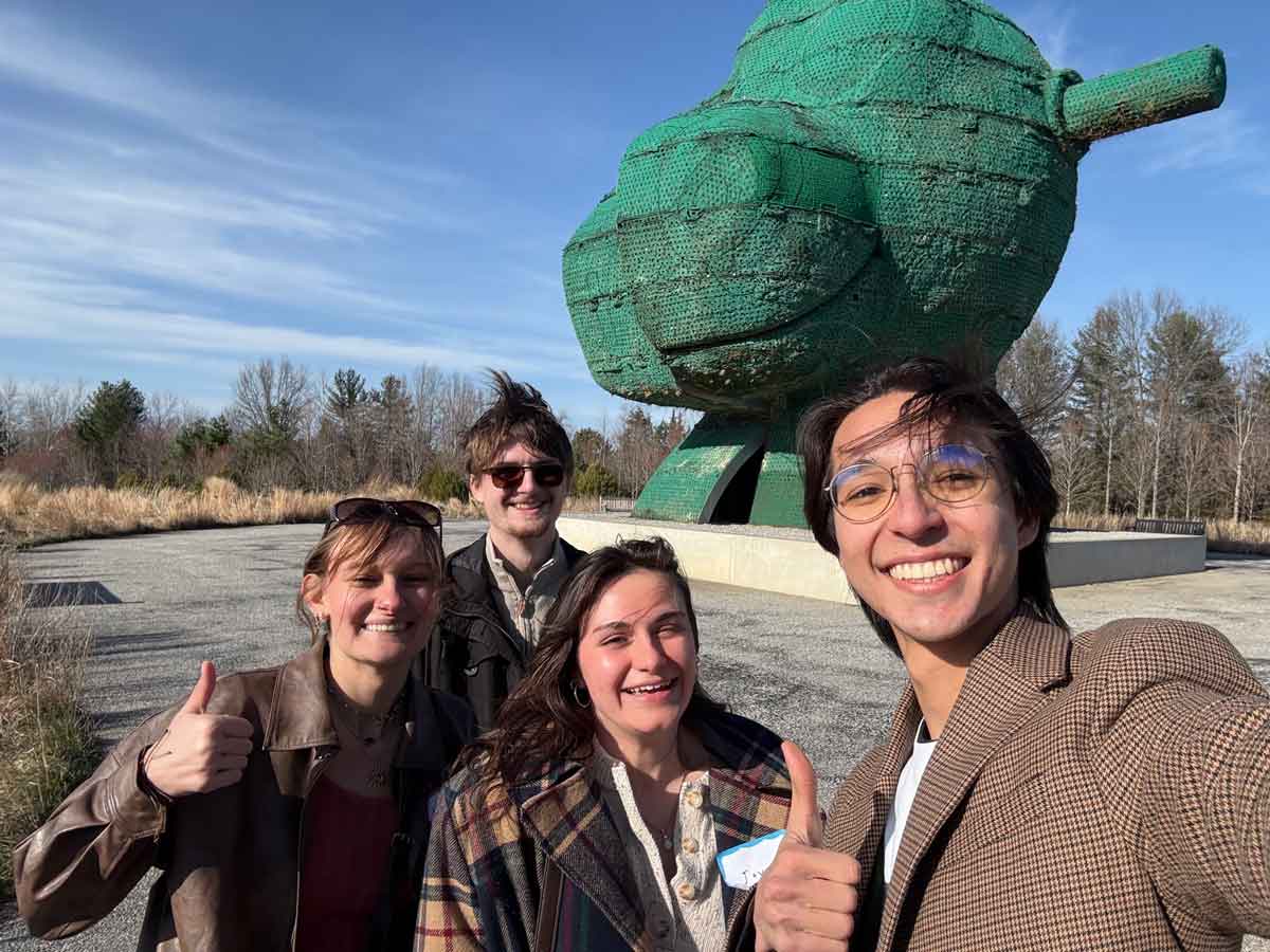 Miami University students smiling in front of outdoor sculpture at Glenstone Museum during field trip.