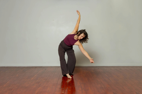 Ashley Goos does a dance pose in the center of the screen