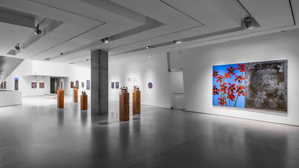 Paintings line the walls and sculptures stand on wooden pedestals in Michael Stillion’s And then it was flowers exhibition.