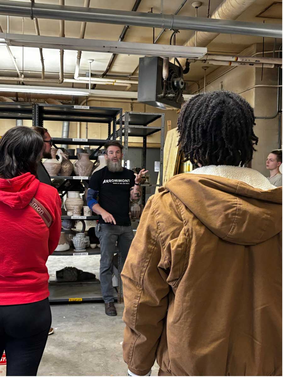 Richard James, Studio Art and Ceramics faculty, speaking with visitors in the ceramics studio during one of the tours.