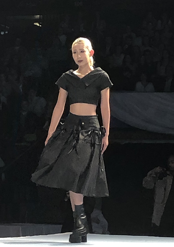 a student walking a runway