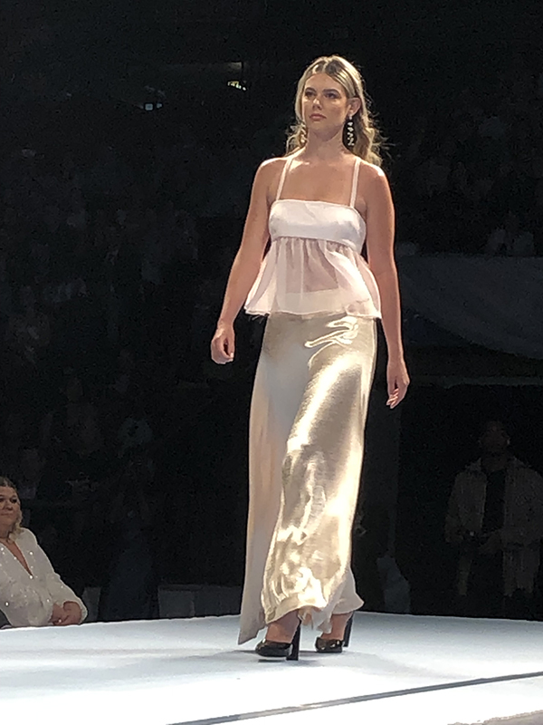 a student walking a runway